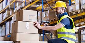 Man in warehouse moving boxes